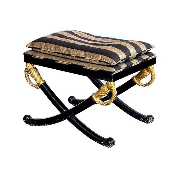 the rectangular upholstered seat above an ebonized wooden frame raised on splayed swords with gilt handles; newer upholstery