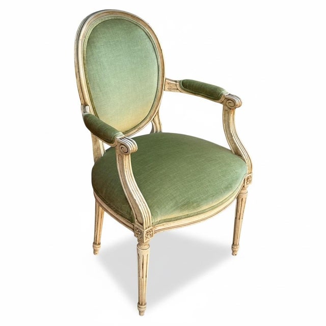 This is a pair of mid-century French Louis XVI style Berger chairs in a vintage green velvet. The medallion back is in a...
