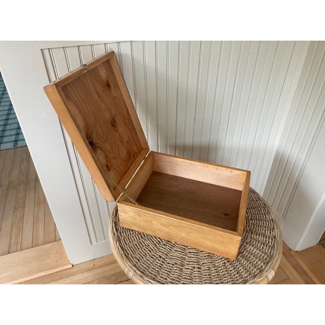 A vintage wood box with brass closure, hinge and chain details. Perfect for storing photos.
