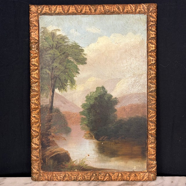 Atmospheric late 19th or early 20th century American oil on board landscape depicting a tranquil body of water surrounded...