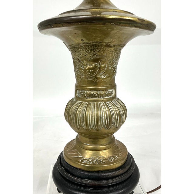 Pretty vintage Asia vase made into table lamp. Hand tooled repousse dragon and clouds decor. Wooden base.