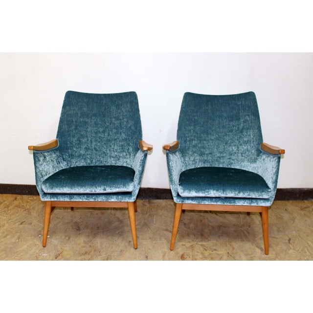 A beautiful set of two armchairs with stunning velver upholstery.