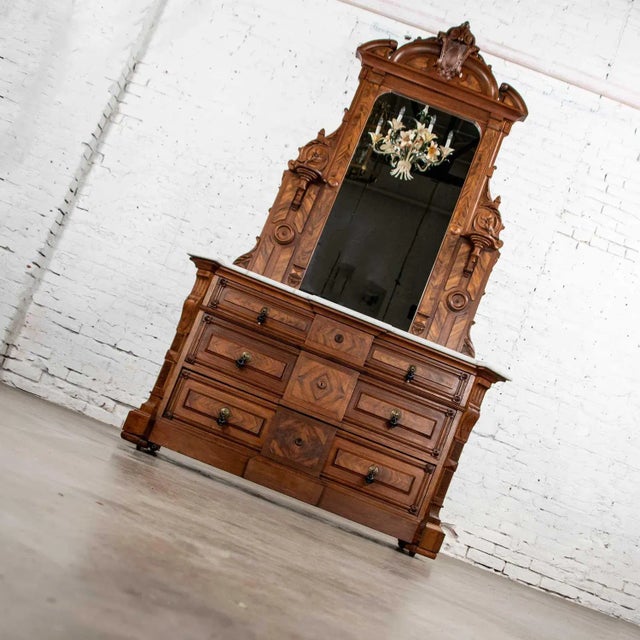 Handsome antique Victorian dresser of solid walnut and burl walnut with white marble top and black painted turned wood and...