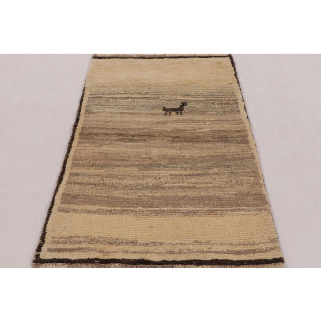 Hand-knotted in wool circa 1950-1960, this 3x4 vintage Persian Gabbeh rug is an enchanting entry in Rug & Kilim’s curation...