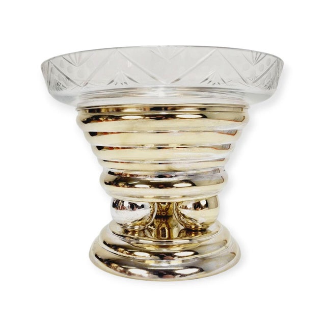 Elegant, large-sized crystal glass centerpiece bowl on a pedestal. It stands on a massive, richly detailed, silver-plated...
