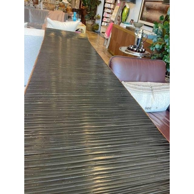 Unique vintage sideboard with Chinese-inspired design. Crafted in warm bamboo with a sleek black lacquered top, six...