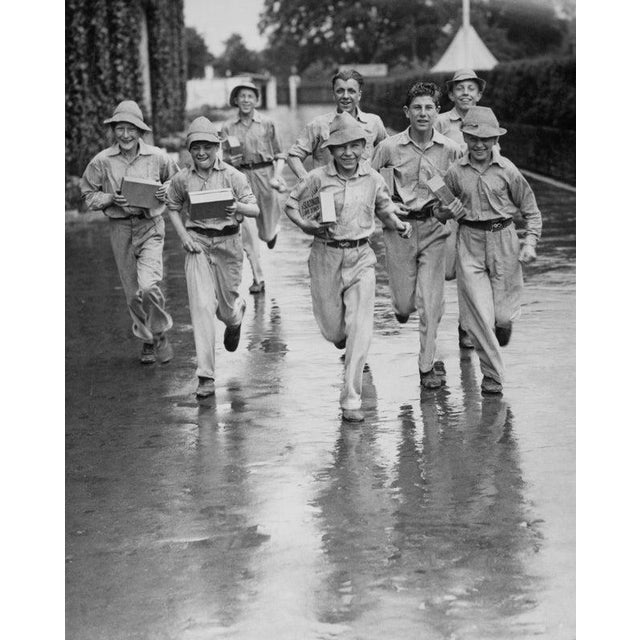 1934 Wimbledon Lawn Tennis Championships Wimbledon ball boys run with boxes of new tennis balls to the courts as rain...