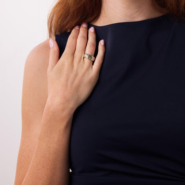 This striking vintage diamond ring is a bold and sophisticated 1980’s design, centered by a GIA-certified round cut...