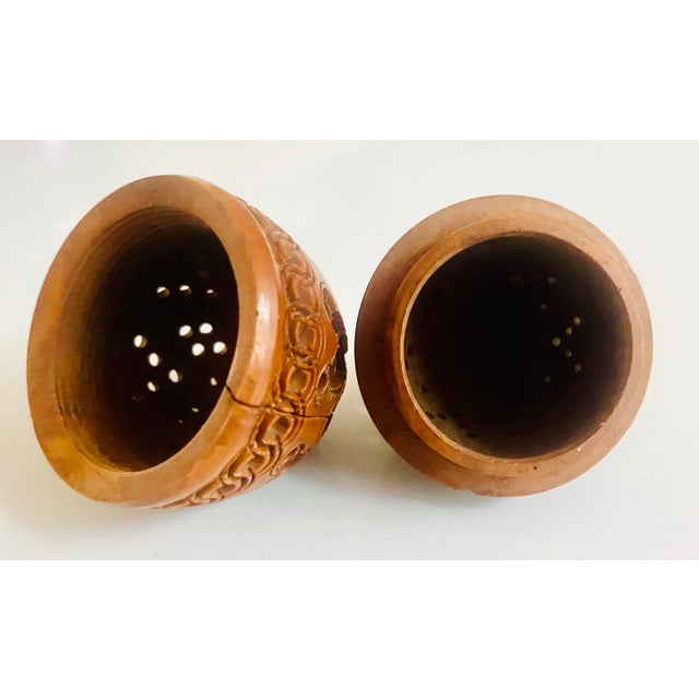 This is an egg-shaped intricately hand-carved coquilla nut box made during the 19th century. Coquilla nut boxes had a...