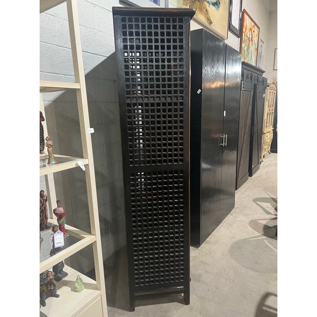 Striking and refined, this Tall Asian Style Dark Wood Lattice Armoire is a beautifully crafted storage piece that blends...