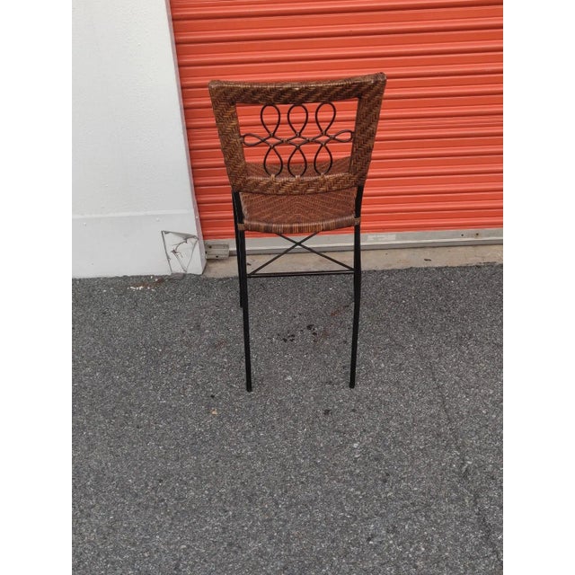 A timeless yet affordable look, this woven rattan Counter Height accent Chair is accented with dark a black metal frame....