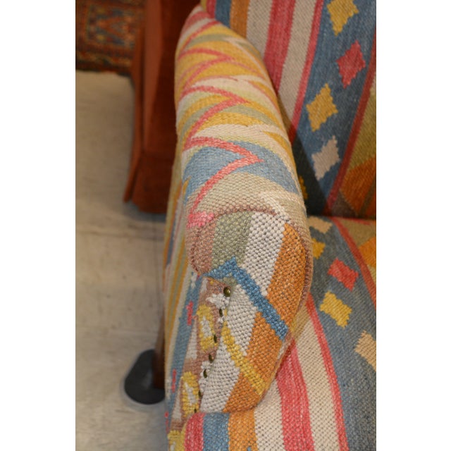 This is a great looking kilim loveseat. 100% wool with poly fill. Made in India. Nail Head accents & wooden legs. This is...