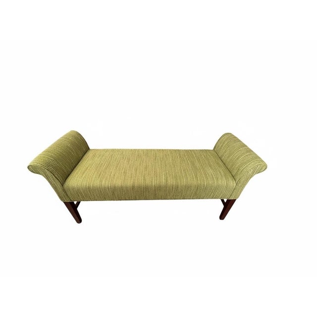 Handsome vintage upholstered window bench or daybed-style settee featuring a long cushioned seat, dramatically rolled...