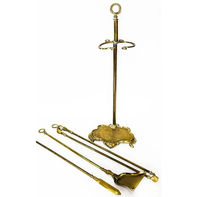 Four piece vintage brass fireplace tool set includes shovel, poker & tongs