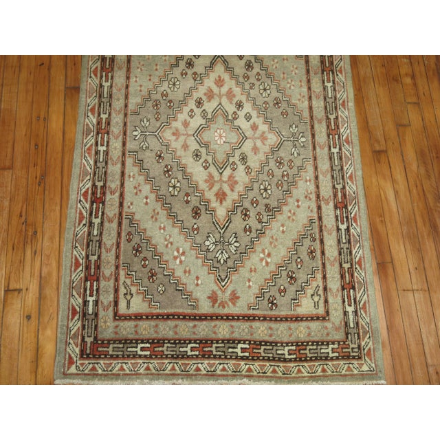 One of our most interesting finds to date. This is a 33 foot Khotan runner with repeating diamond motifs in earth-tone...