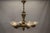 Elegant French Art Deco chandelier with six sculptural frosted glass shades and refined bronze arms, circa 1930. This...