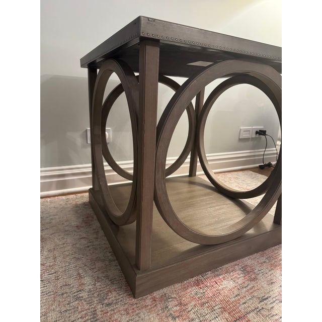 Metal and wood end table. Wood is a gray wash and metal top has decorative "nailhead" trim. Piece is about ten years old...