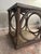 Metal and wood end table. Wood is a gray wash and metal top has decorative "nailhead" trim. Piece is about ten years old...