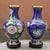 This is a striking pair of large vintage cloisonné enamel vases, crafted from a copper body with intricate wire inlay....