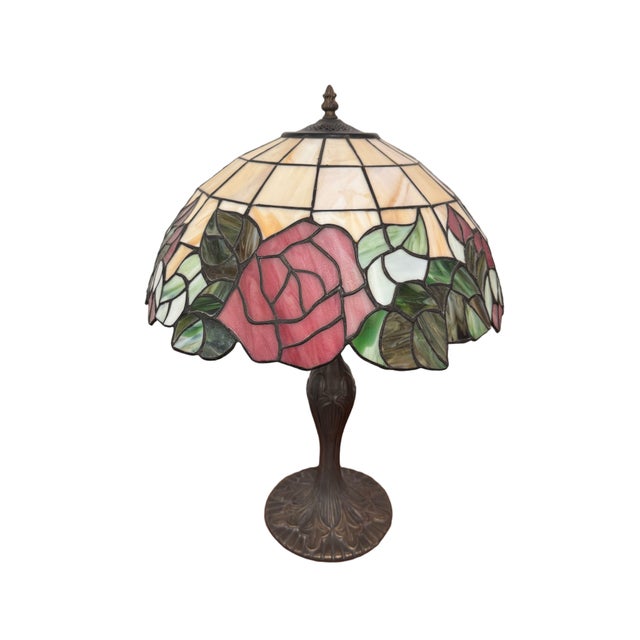 A charming vintage Art Nouveau style table lamp dating to circa 1990s, featuring a decorative stained glass shade adorned...