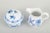 Meissen blue onion sugar bowl and creamer, mid-20th century. A set consisting of a classic lidded sugar bowl and a creamer...