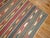 A handmade early 20th century tribal Kilim with beautiful array of colors. Measures: 5'10" x 10'1".