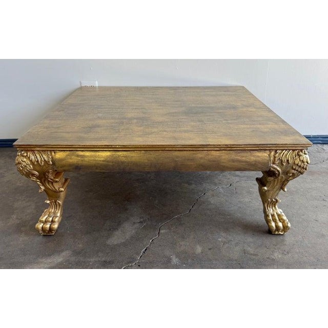 This striking carved wood coffee or low table features a genuine gold leaf finish and is designed in the Baroque style....