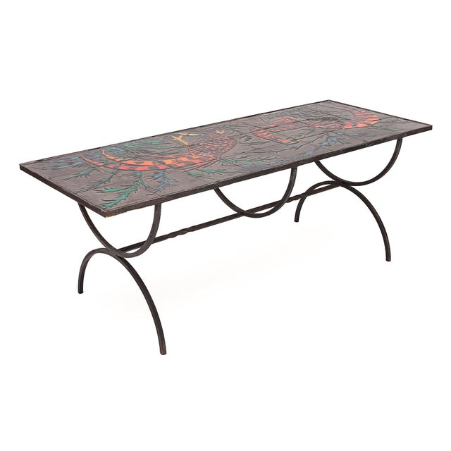 Wrought iron coffee table. Top in ceramic art tiles depicting grouse. Very bright. Circa 1950.