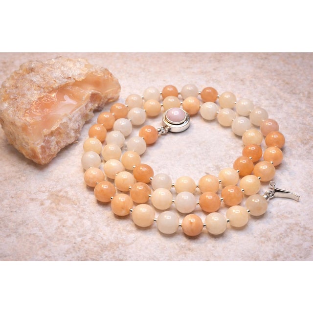 The length of the necklace is 24.5 inches (61 cm). The size of the smooth round beads is 10.5mm. Beads are a very gentle...
