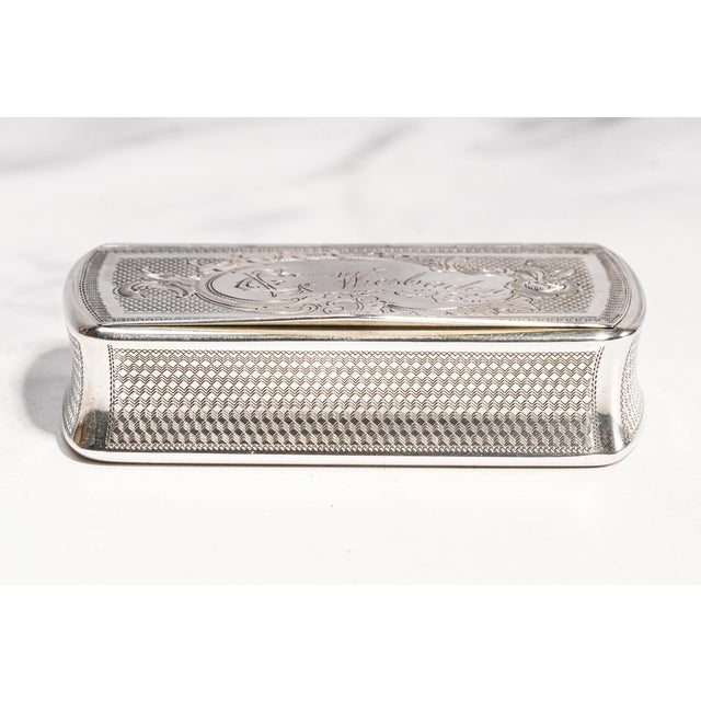 A beautifully preserved example of Victorian craftsmanship, this antique 800 European silver snuff box captures the...