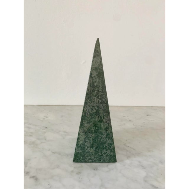 A beautifully proportioned marble obelisk in richly veined shades of green and grey. The sculptural silhouette and...