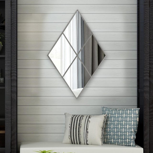 The Diamond Mirror resembles a beautifully paneled window. The metal frame is finished in an antique silver to perfectly...