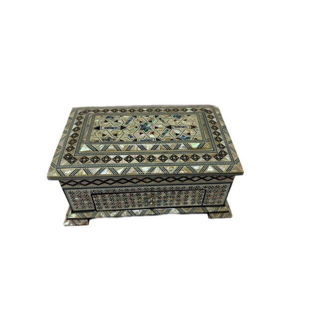 Handcrafted in Egypt, this elegant wooden jewelry box features intricate traditional inlay work using genuine Mother of...