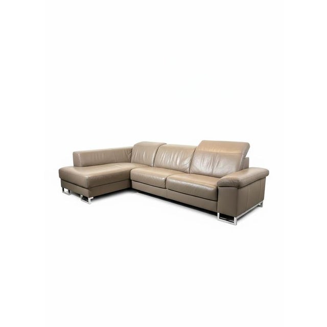 A spacious and contemporary leather corner sofa in an elegant taupe tone, designed for ultimate comfort and modern living....