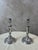 A charming pair of silver-plated metal candlesticks dating from the early 20th century, inspired by the Louis XVI...