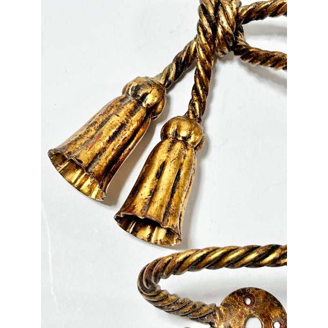 Elegant pair of vintage Italian gilt rope curtain tiebacks featuring twisted rope detailing and sculptural tassel finials....