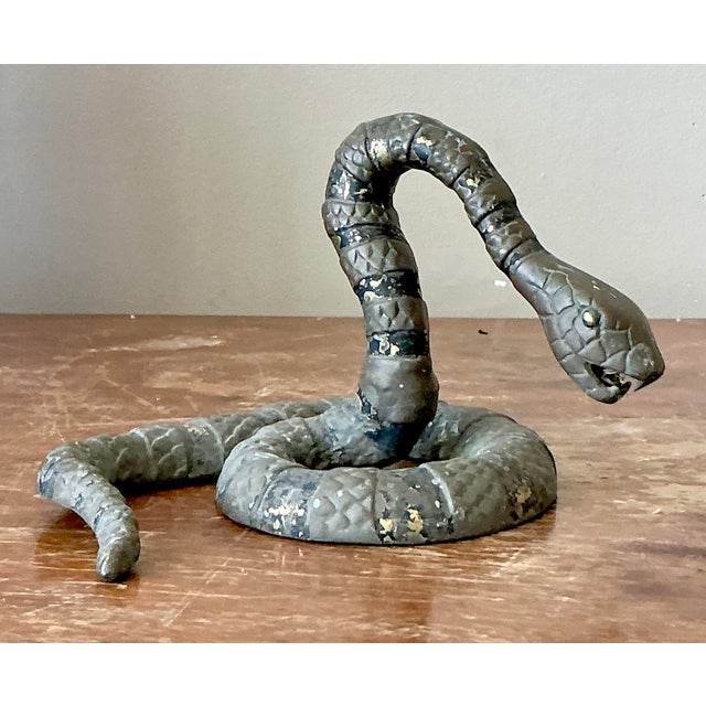 Embrace the allure of the exotic with this captivating vintage bronze snake sculpture, a truly distinctive decorative...