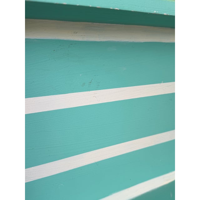 Hand-painted coastal wood tray featuring whimsical beach cottage and palm tree accents in cheerful pastel hues. A charming...