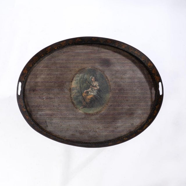Oval tole tray on stand. Tray comes off of stand, not fixed. Detailed picture of woman and along the interior edge of the...
