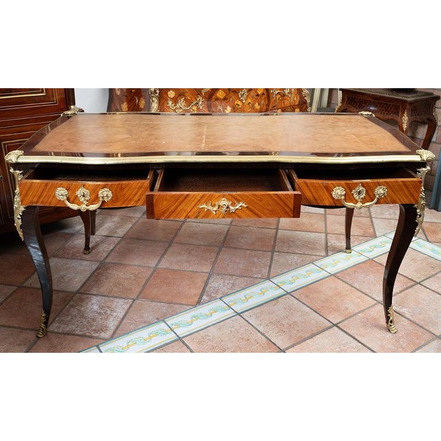 Antique French Napoleon III desk made of fine exotic wood with finely chased gilt-bronze accents. The top features an...