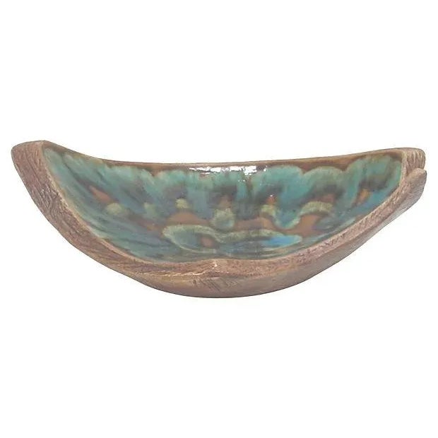 A California Pottery ceramic faux bois asymmetrical console bowl in a vibrant turquoise and brown drip style glaze. This...