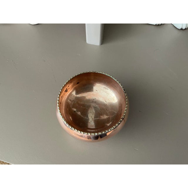 Darling old copper bowl with brass feet. Old copper (not marked) and lines with silver over copper which you can see is...
