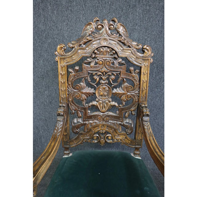 Highly carved throne chair in medieval design on Walnut frame