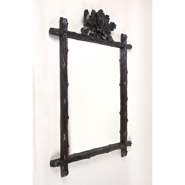Exceptional black forest mirror from the late 19th century in austria around 1870. This phenomenal, elaborately hand...