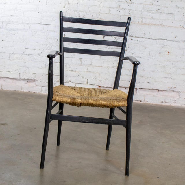 Wonderful vintage Italian MCM a.k.a. Mid-Century Modern ladderback armchair composed of a black painted frame and a...