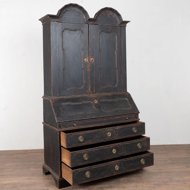 Early 19th century tall Danish Baroque secretary, crafted in oak. A newer professionally applied black painted finish is...