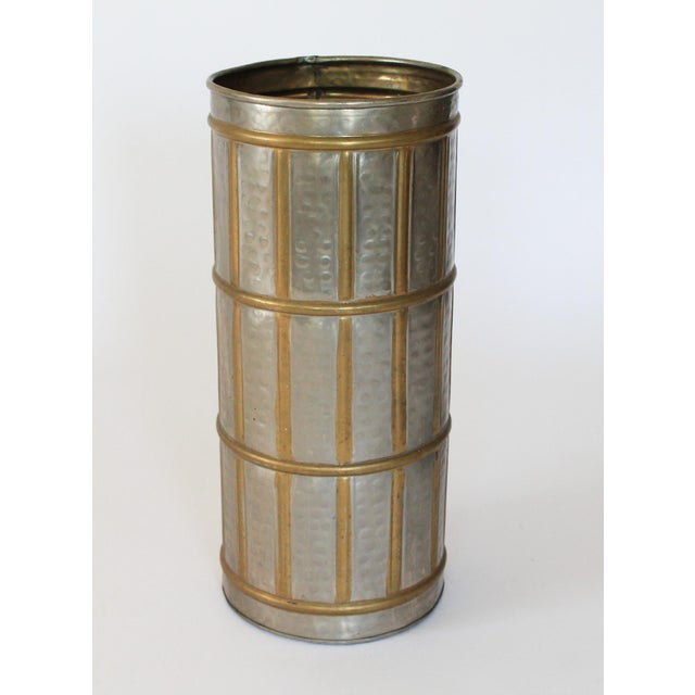 Vintage hammered silver tone and brass umbrella holder. Marked "Made in India" on the bottom. Overall age wear. Some small...