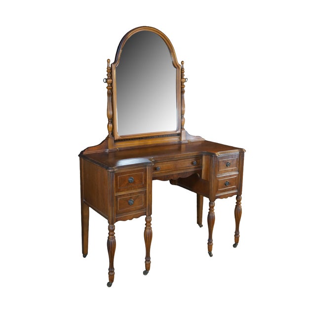 This circa 1930s Early American revival vanity is an elegant dressing table crafted from hardwood and matched walnut...