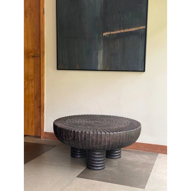 Elevate your living space with this striking large round sofa table, meticulously handcrafted from solid suar wood....