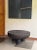 Elevate your living space with this striking large round sofa table, meticulously handcrafted from solid suar wood....